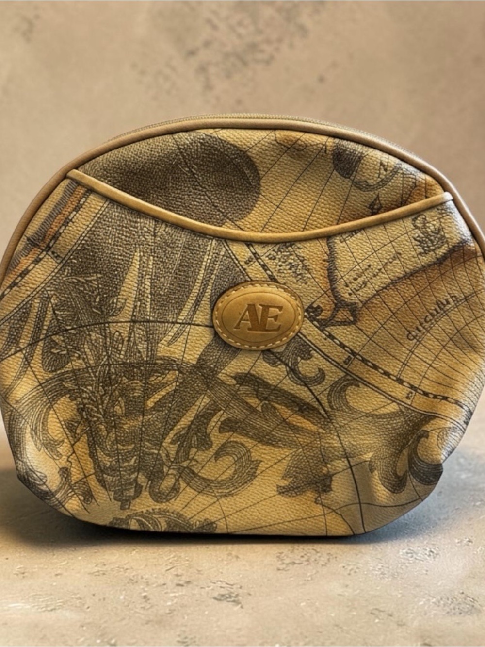 Allan Edward’s clutch bag with wrist handle.  Brown Map Design.
